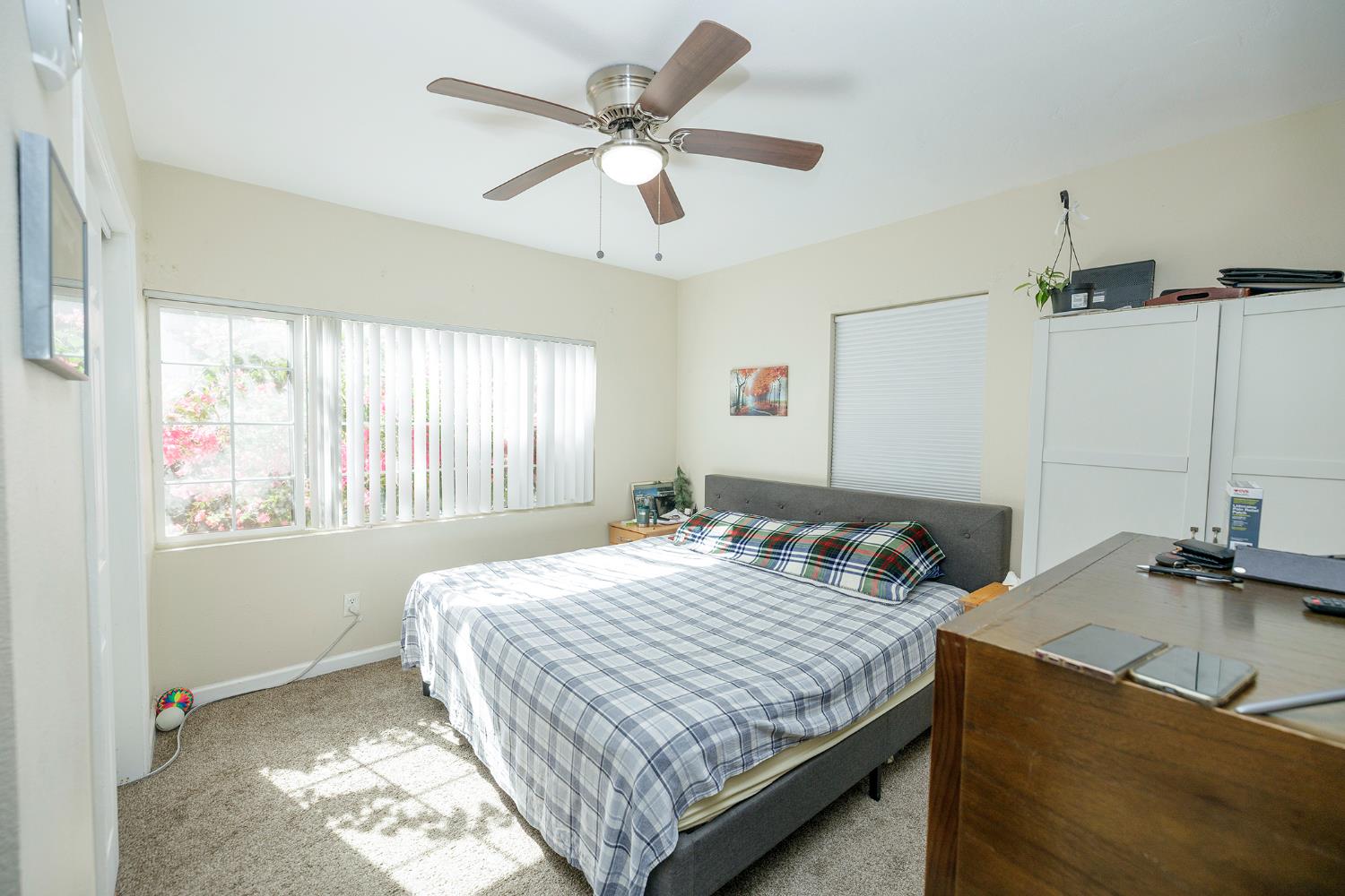 421 East 8th Street Stockton, CA 95206 - Photo 16 of 20 a bedroom with a bed and a chandelier