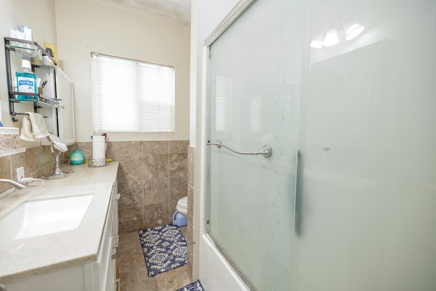 421 East 8th Street Stockton, CA 95206 - Photo 17 of 20 a bathroom with a sink a toilet and shower