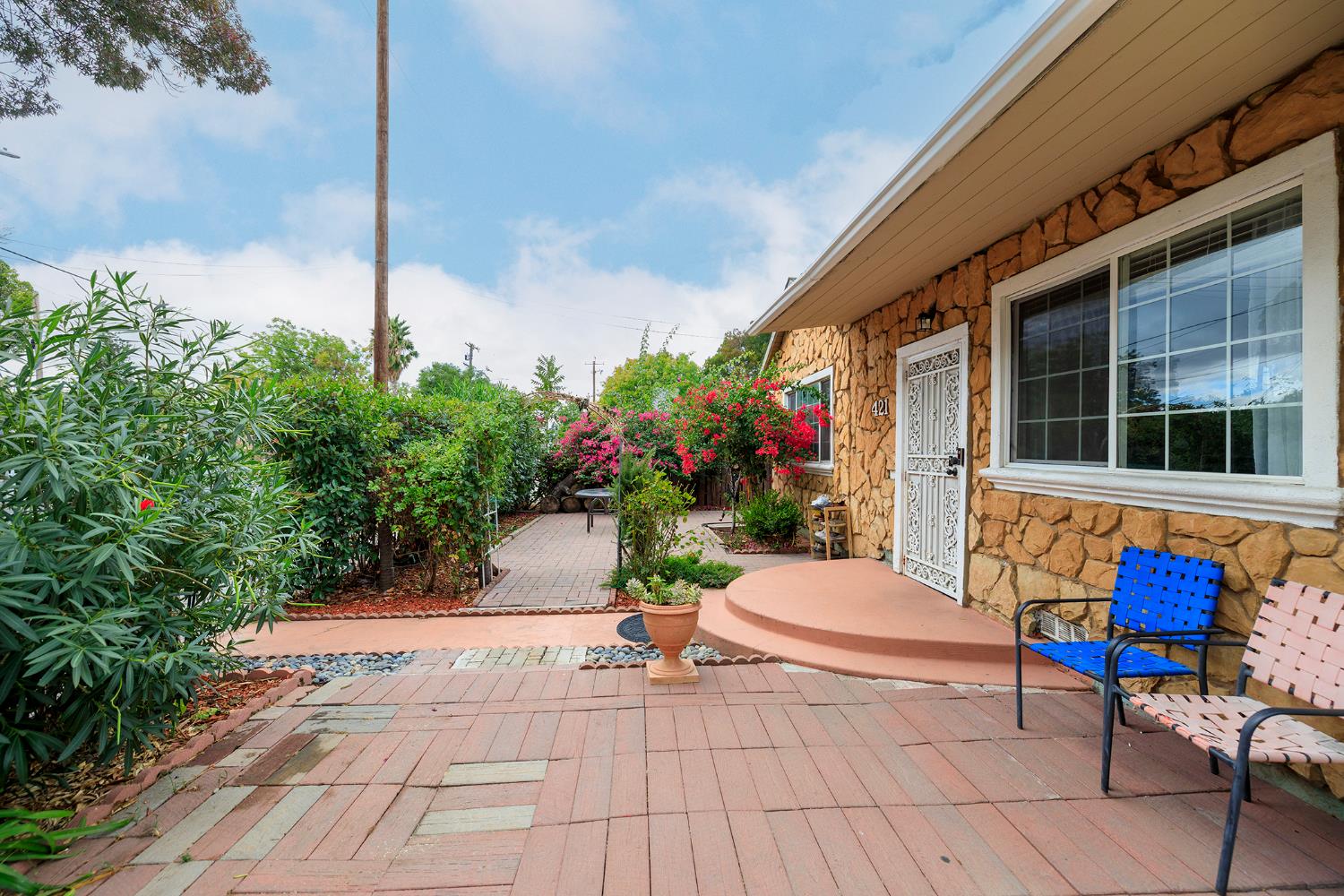 421 East 8th Street Stockton, CA 95206 - Photo 3 of 20 a view of a patio with a table and chairs potted plants