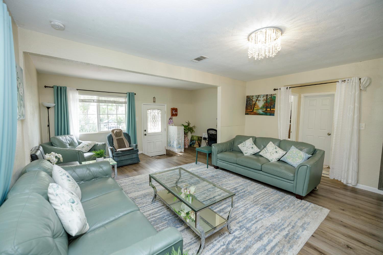 421 East 8th Street Stockton, CA 95206 - Photo 6 of 20 a living room with furniture and a wooden floor