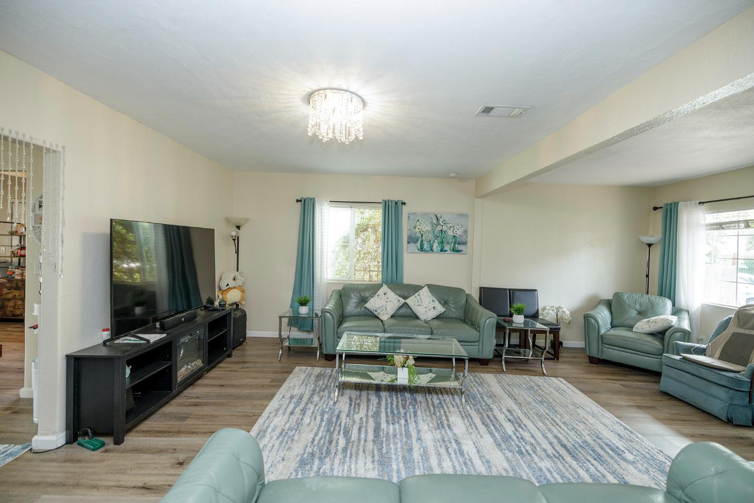 421 East 8th Street Stockton, CA 95206 - Photo 7 of 20 a living room with furniture and a flat screen tv