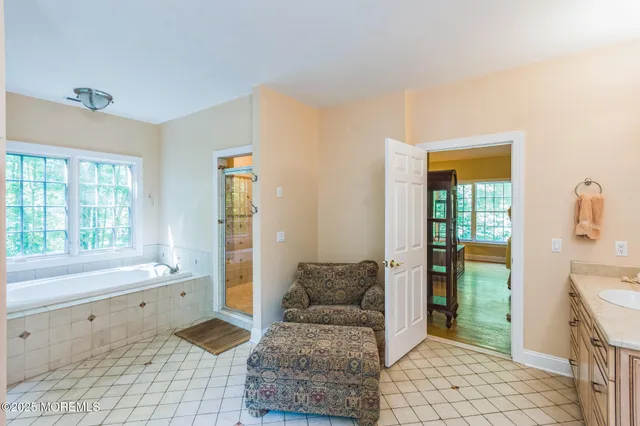 a spacious bathroom with a bathtub and a shower