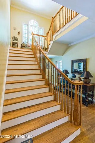 a view of entryway and hall with wooden floor