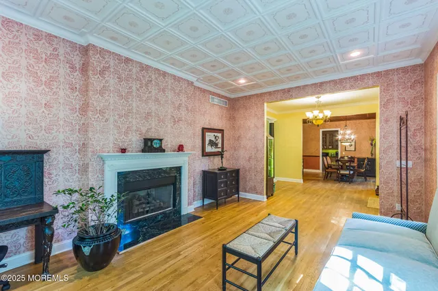 a living room with furniture dining table and a fireplace