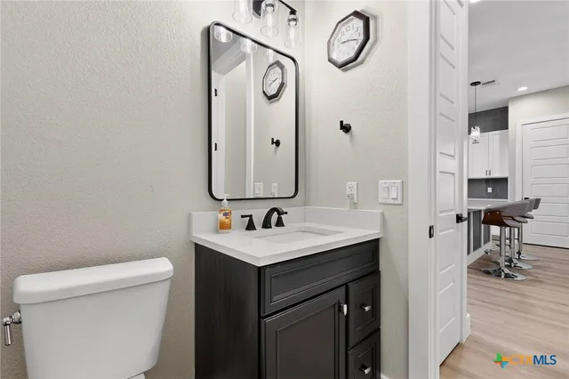 a bathroom with a toilet sink and mirror