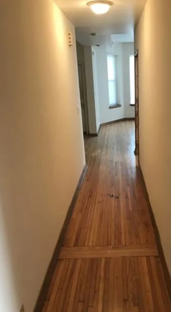 1808 South Drake Avenue Chicago, IL 60623 - Photo 4 of 14 a view of a hallway with wooden floor