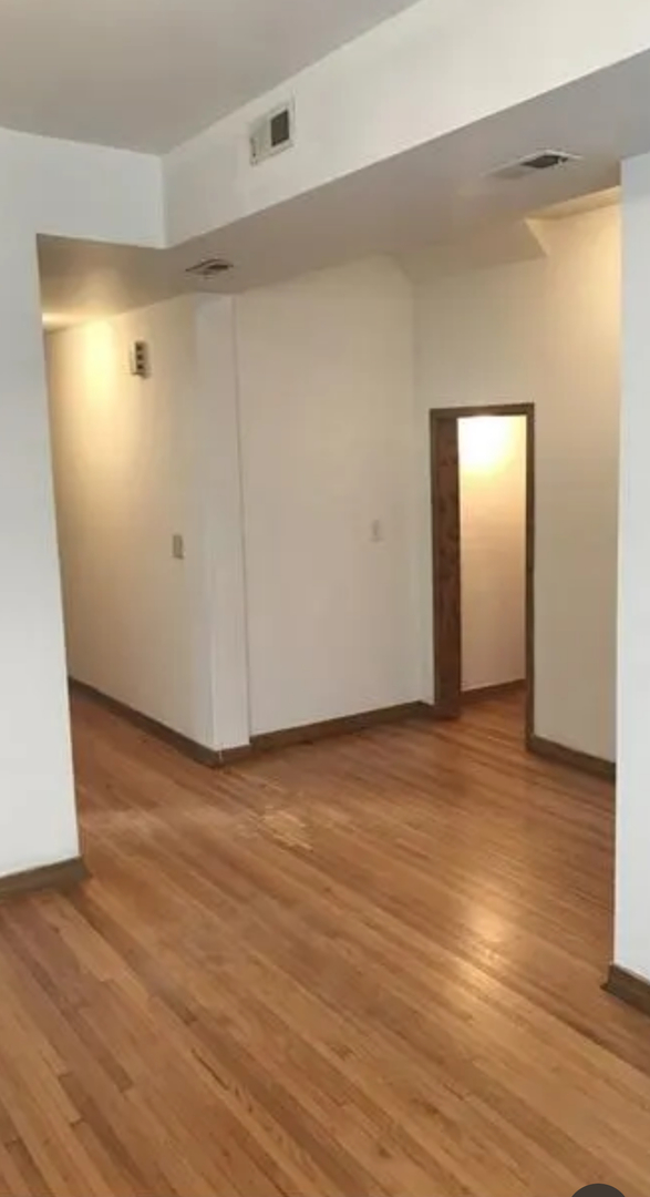 1808 South Drake Avenue Chicago, IL 60623 - Photo 5 of 14 a view of an empty room and wooden floor