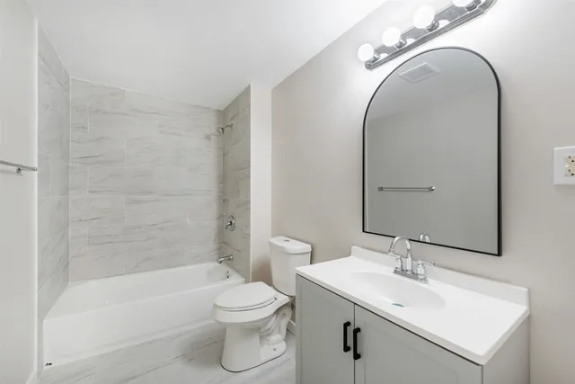 a bathroom with a sink a toilet and a mirror