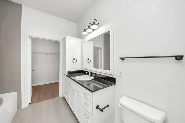 a view of walk in closet with wooden floor