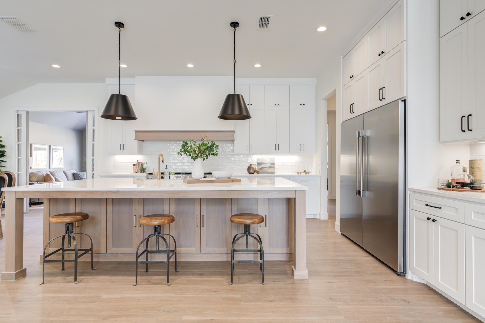 3608 144th Street Lubbock, TX 79423 - Photo 11 of 51 a kitchen with kitchen island a dining table chairs sink and cabinets