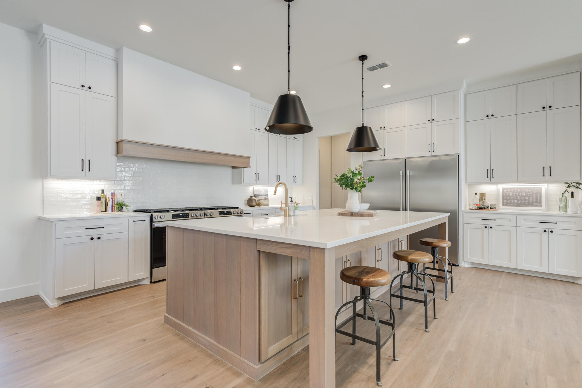 3608 144th Street Lubbock, TX 79423 - Photo 14 of 51 a kitchen with kitchen island a stove a chandelier and a refrigerator