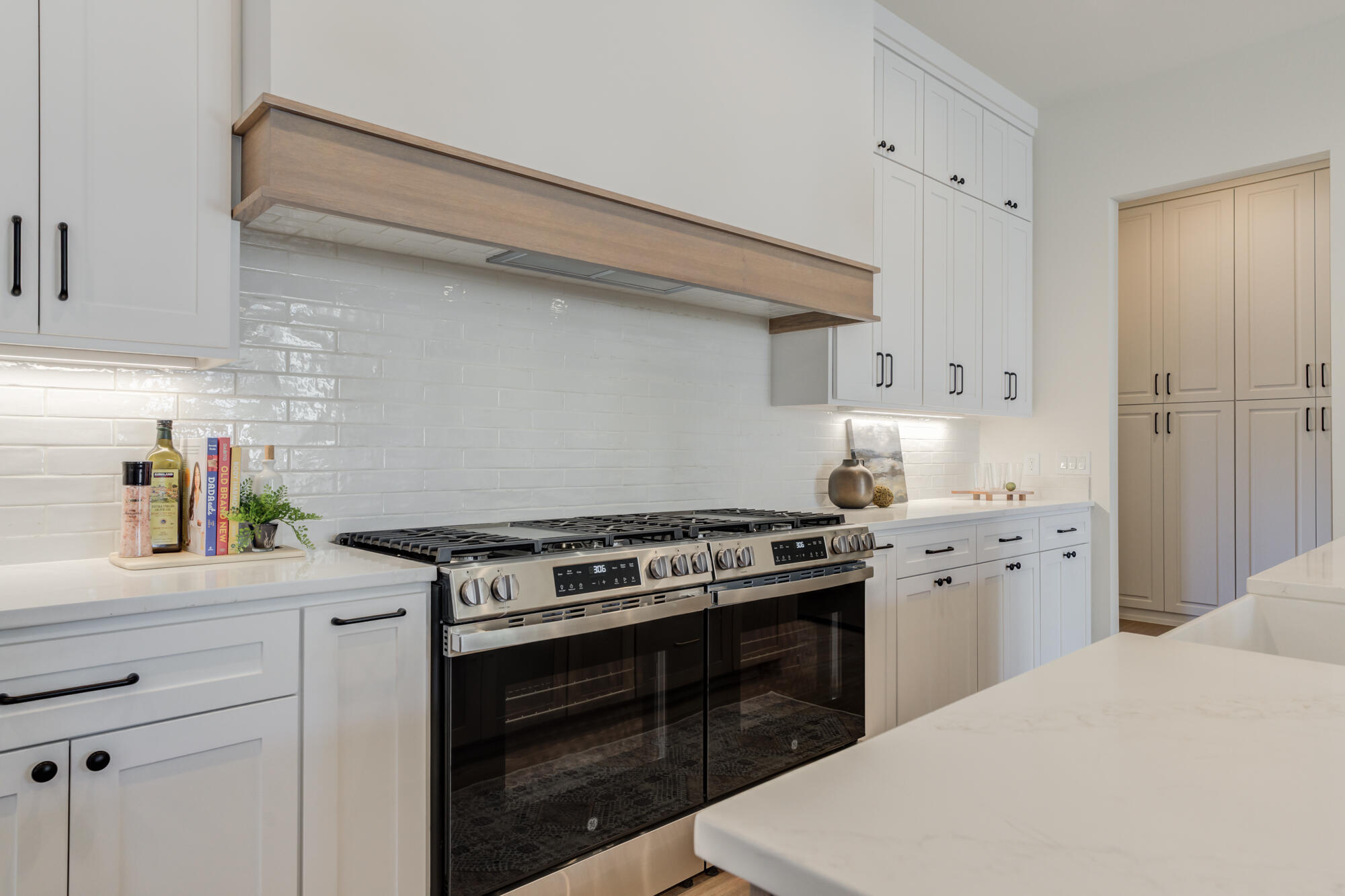 3608 144th Street Lubbock, TX 79423 - Photo 16 of 51 a kitchen with stainless steel appliances a stove and white cabinets