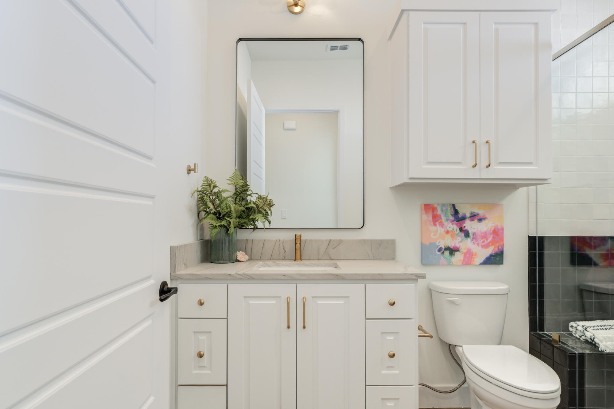 3608 144th Street Lubbock, TX 79423 - Photo 34 of 51 a bathroom with a sink a toilet and vanity
