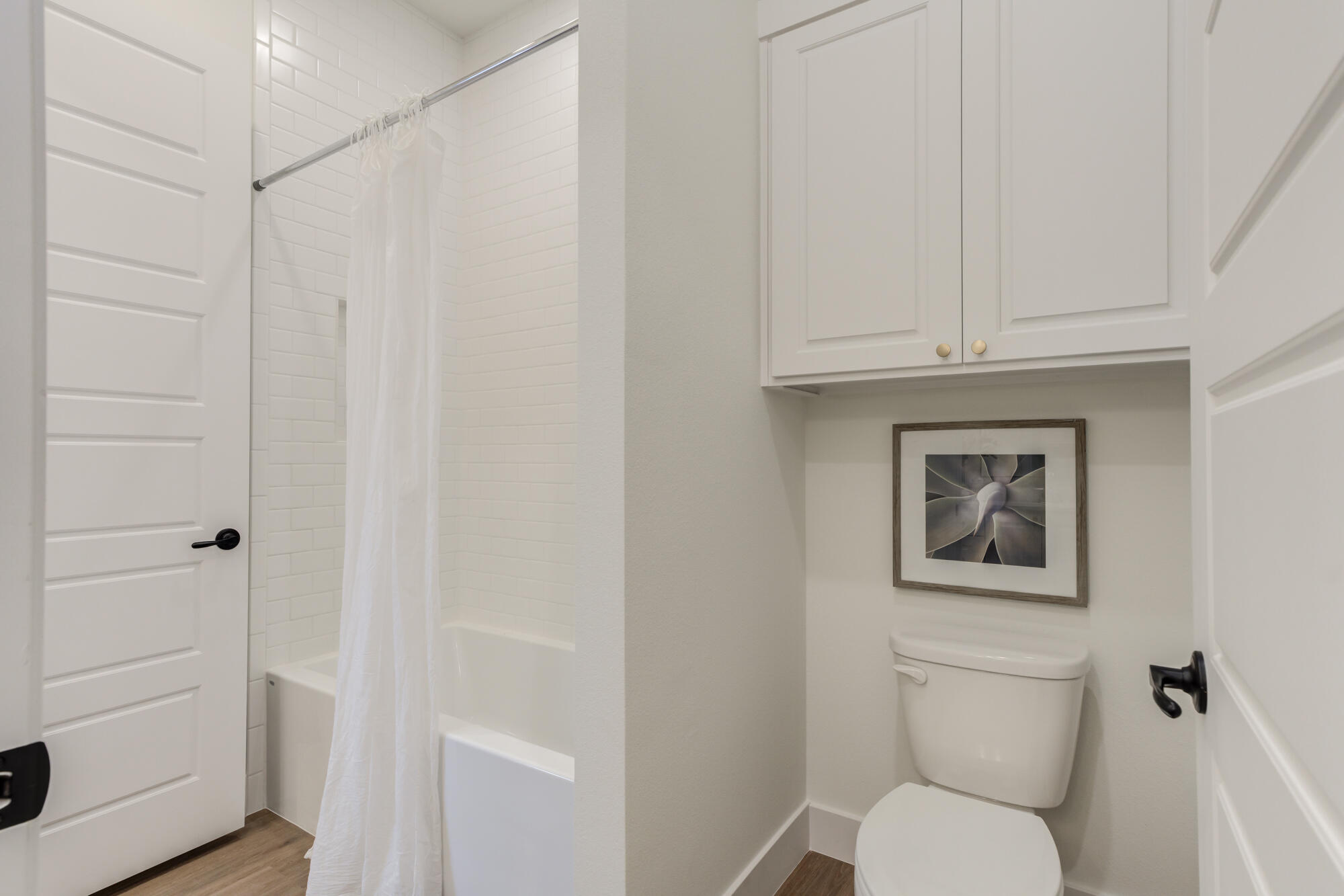 3608 144th Street Lubbock, TX 79423 - Photo 38 of 51 a white toilet sitting next to a bathroom sink