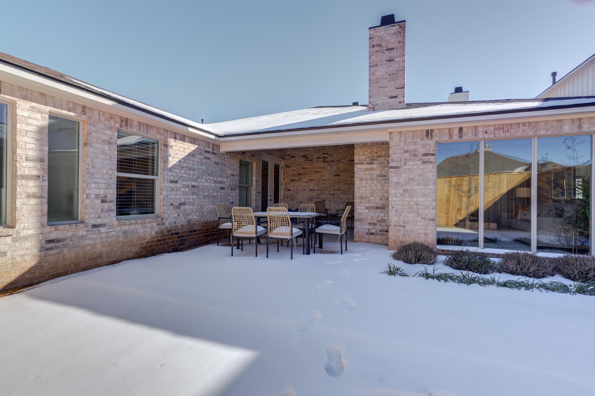 3608 144th Street Lubbock, TX 79423 - Photo 48 of 51 a view of a patio with table and chairs with wooden fence and plants