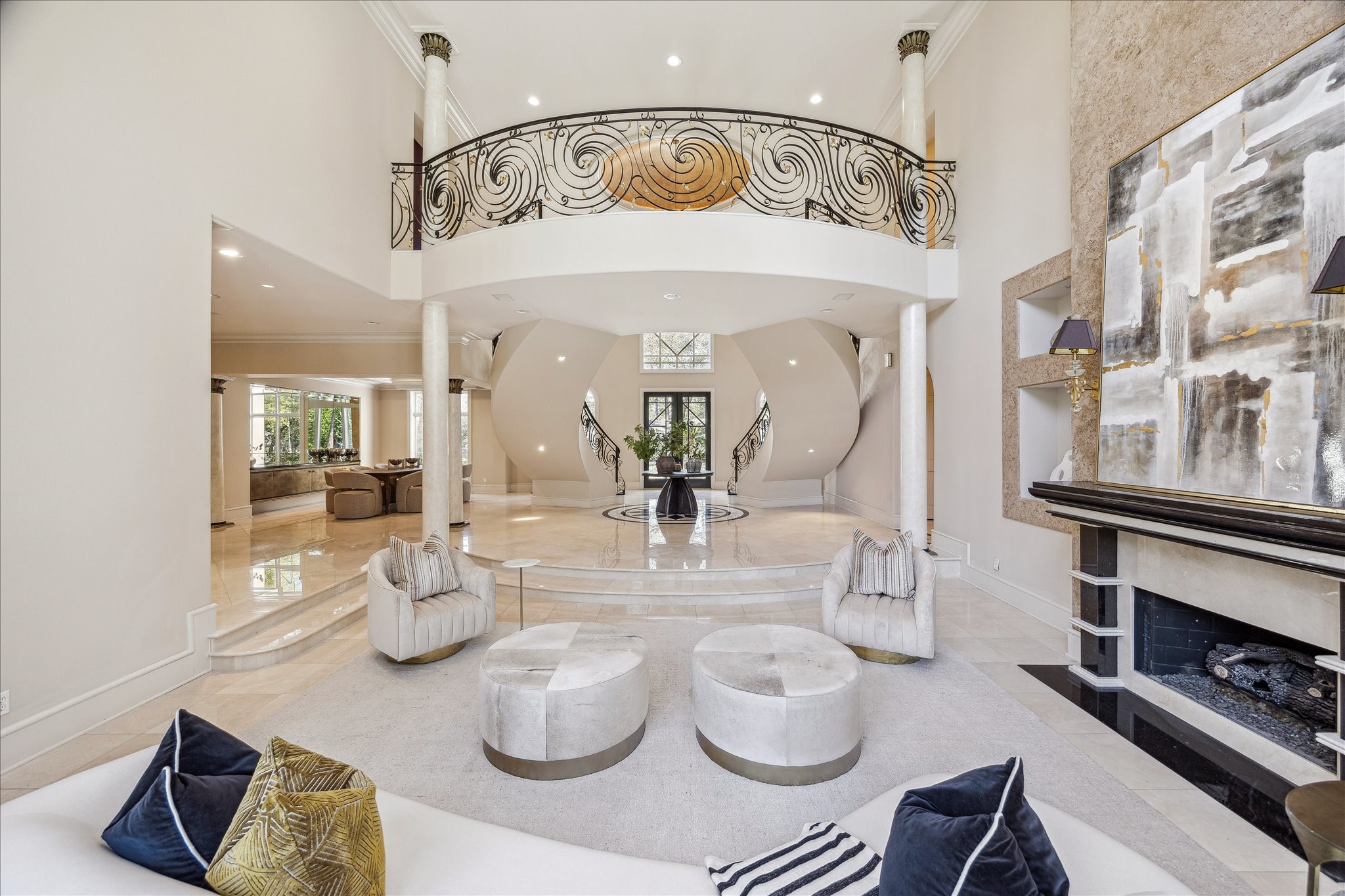 608 Little John Lane Houston, TX 77024 - Photo 21 of 46 Bright and inviting, the formal dining room showcases elegant architectural details, including a tray ceiling and double crown molding. Recessed lighting highlights the custom built-in buffet with granite countertop and mirror-backed niche. Western-facing windows fill the space with natural light, creating a sophisticated setting for gatherings and special occasions.