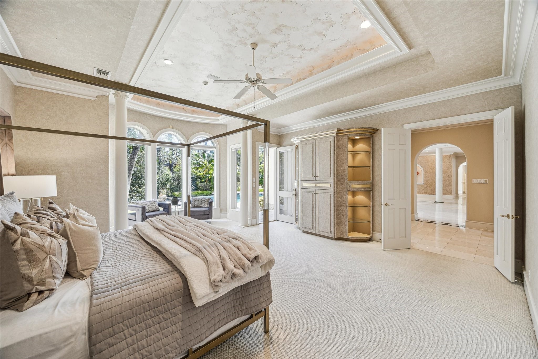 608 Little John Lane Houston, TX 77024 - Photo 26 of 46 Ample storage is seamlessly integrated with custom built-in cabinetry, balancing style and function. The combination of recessed lighting, designer finishes, and serene vistas makes this bedroom a perfect sanctuary.