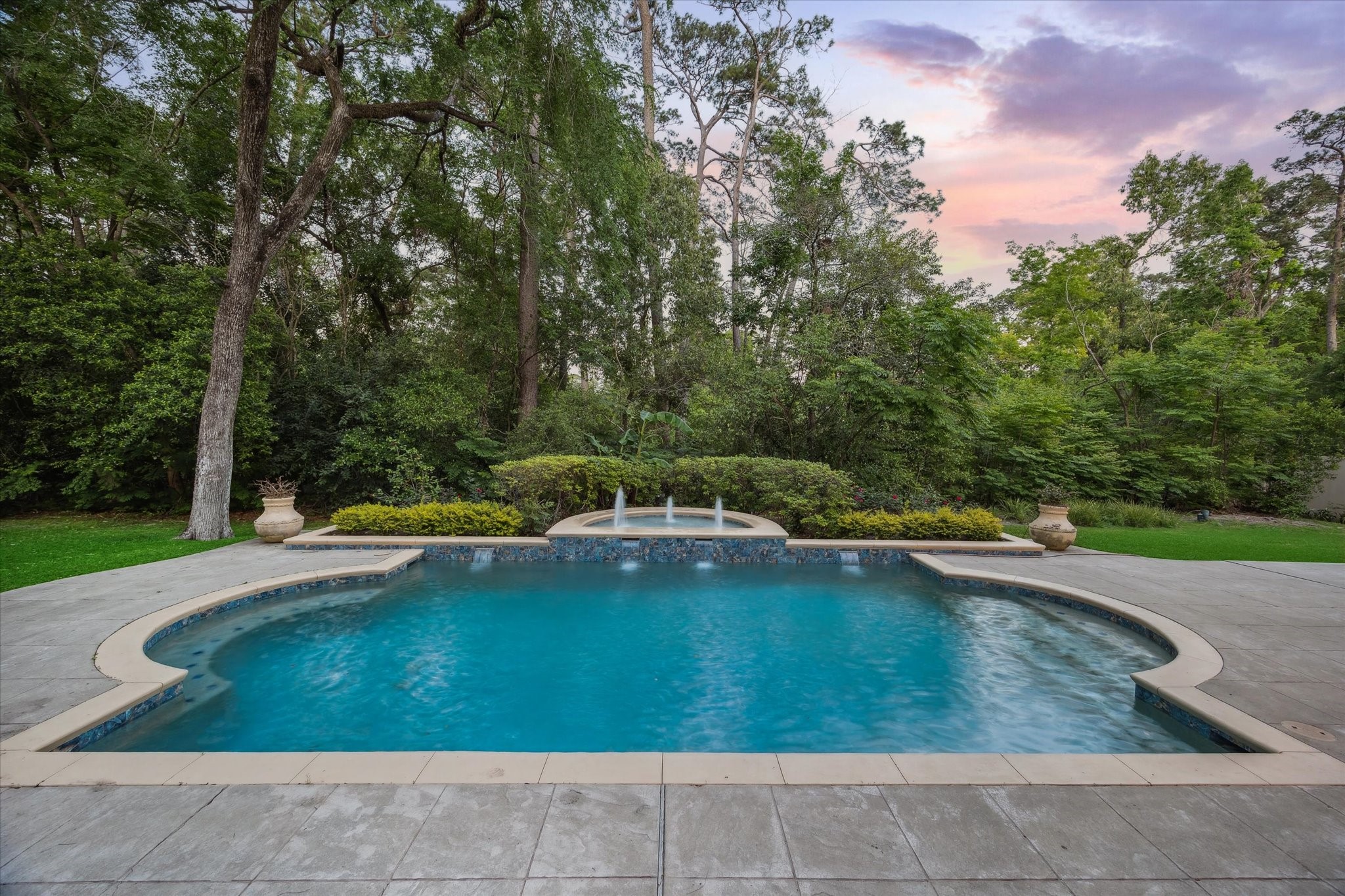 608 Little John Lane Houston, TX 77024 - Photo 3 of 46 Framed by landscaping and accented by pool fountains, the backyard is a serene and luxurious
retreat. Lounge in the sun or dine
under the stars in this private haven. The ambiance is pure resort living.