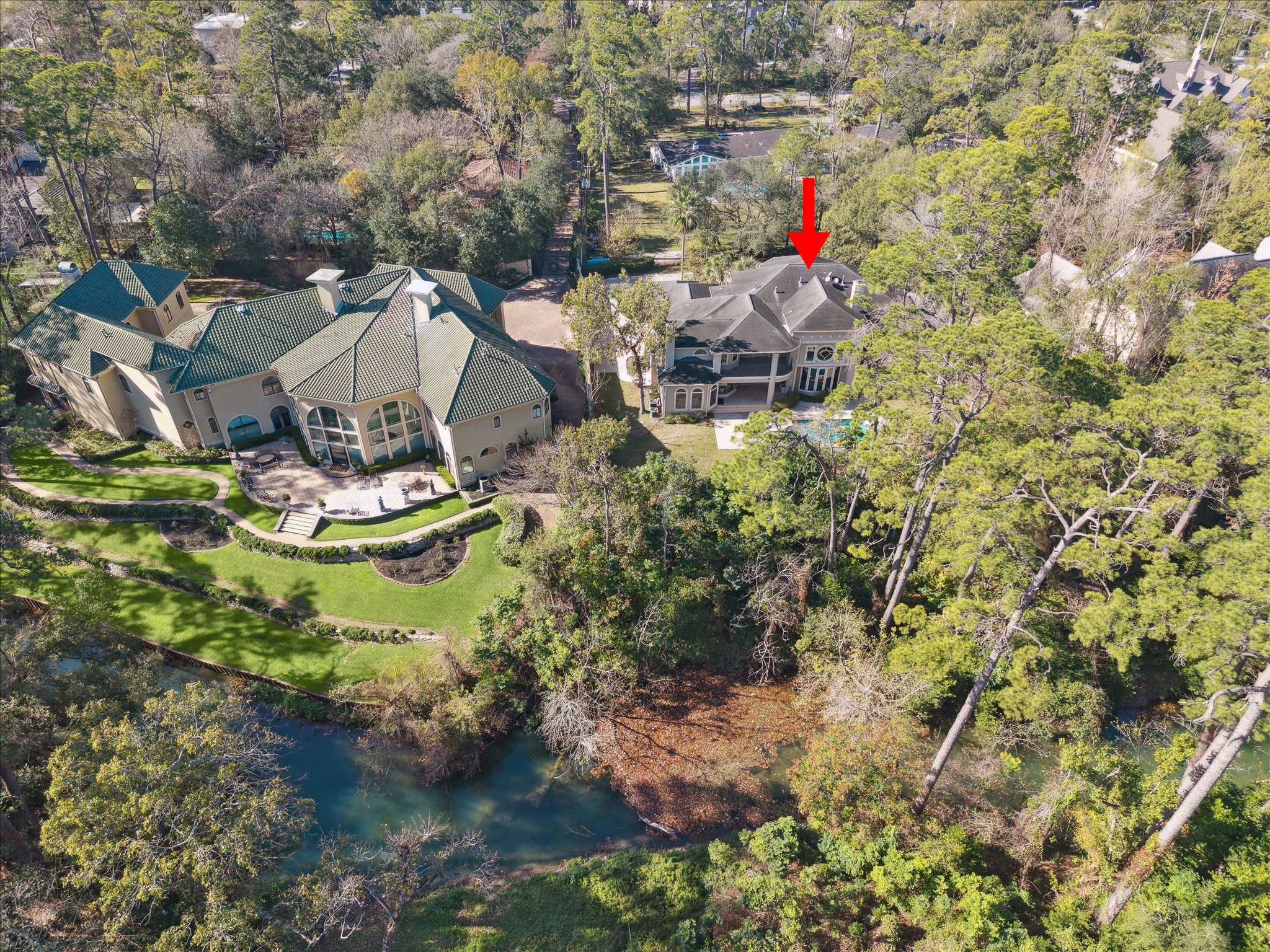 608 Little John Lane Houston, TX 77024 - Photo 45 of 46 Aerial views showcase the full potential of the backyard, highlighting opportunities to create expansive outdoor living, entertain, or design a serene oasis. Imagine open spaces all framed by the home’s private and picturesque setting. This perspective allows you to envision the backyard as a versatile extension of the home’s luxurious lifestyle.