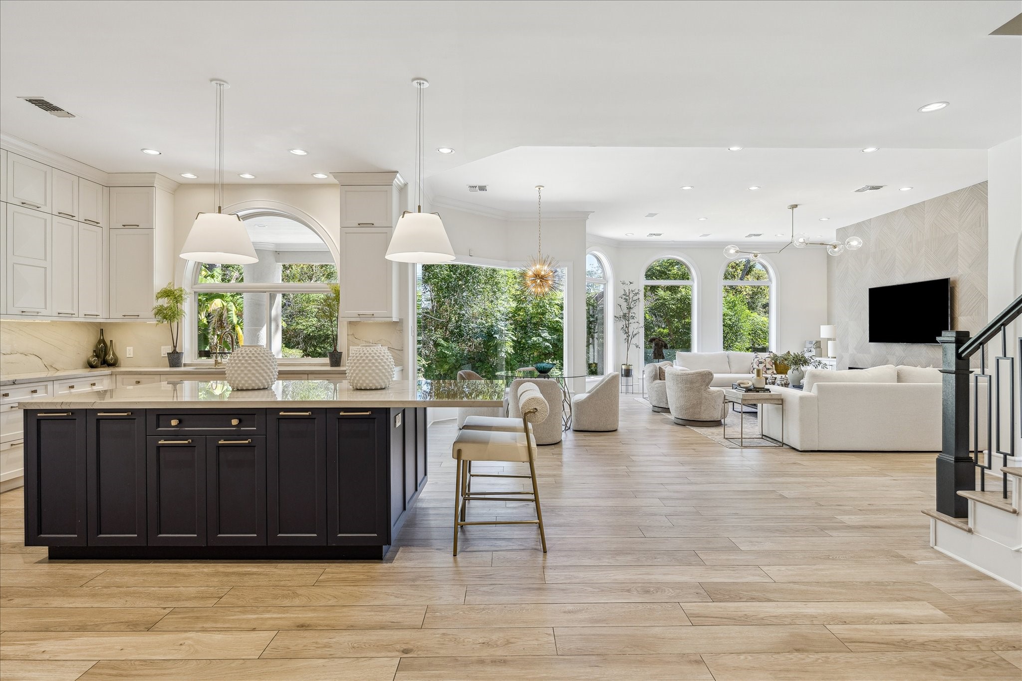608 Little John Lane Houston, TX 77024 - Photo 5 of 46 This expansive open-concept layout
fosters seamless living and
entertaining with uninterrupted flow
between the kitchen, breakfast room,
and family space. Designer lighting,
custom cabinetry, and quartzite
countertops bring texture and depth.
It’s refined, comfortable, and
perfectly tailored to modern life.