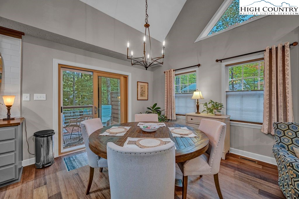 607 Charter Hills Road Beech Mountain, NC 28604 - Photo 20 of 31 a view of a dining room with furniture window and wooden floor