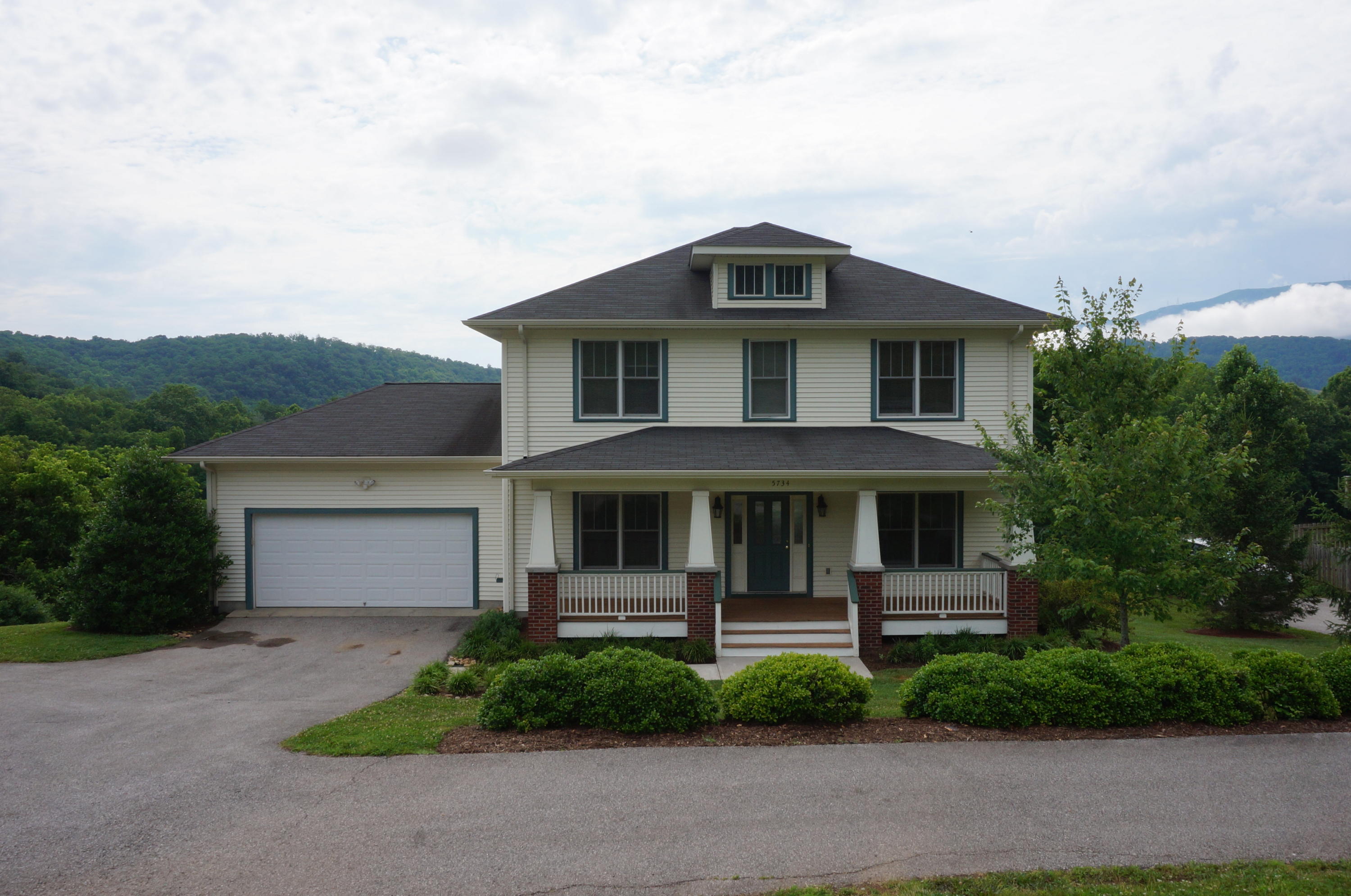 5734 North Fork Road Elliston, VA 24087 - Photo 1 of 27 a front view of a house with garage and plants