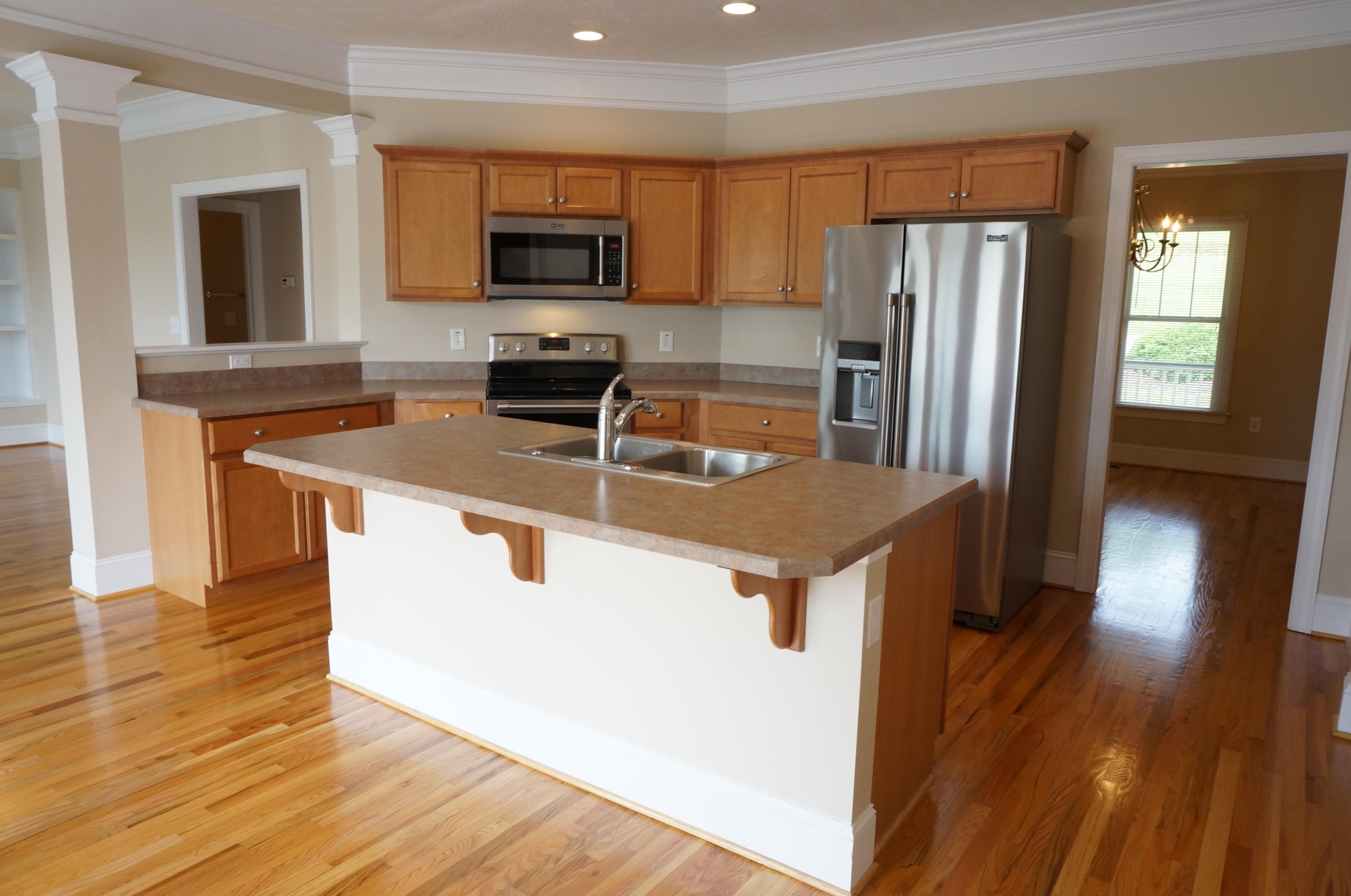 5734 North Fork Road Elliston, VA 24087 - Photo 2 of 27 a kitchen with kitchen island a refrigerator sink and microwave