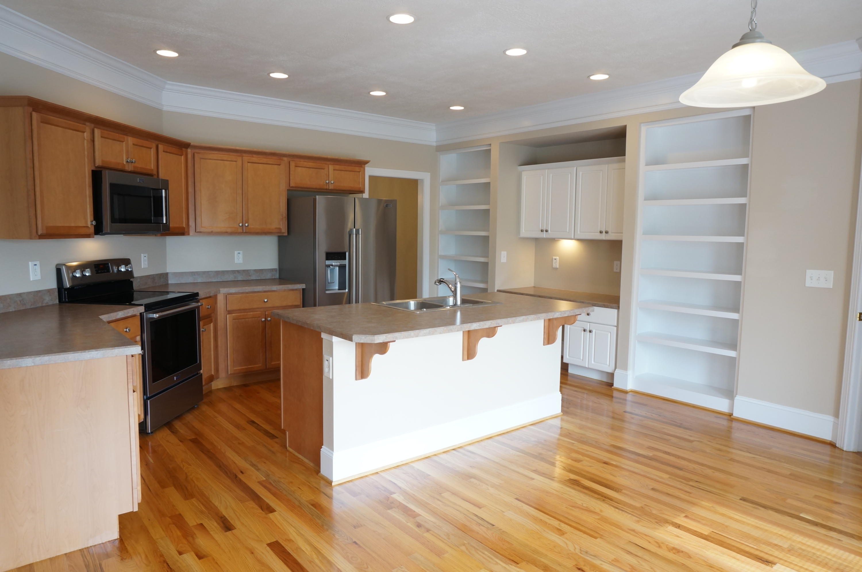 5734 North Fork Road Elliston, VA 24087 - Photo 3 of 27 a kitchen with kitchen island granite countertop wooden cabinets and a sink