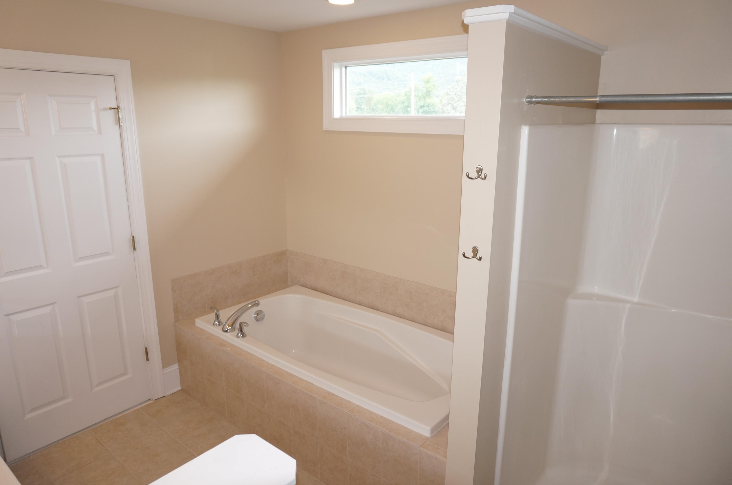 5734 North Fork Road Elliston, VA 24087 - Photo 21 of 27 a white bath tub sitting next to a toilet
