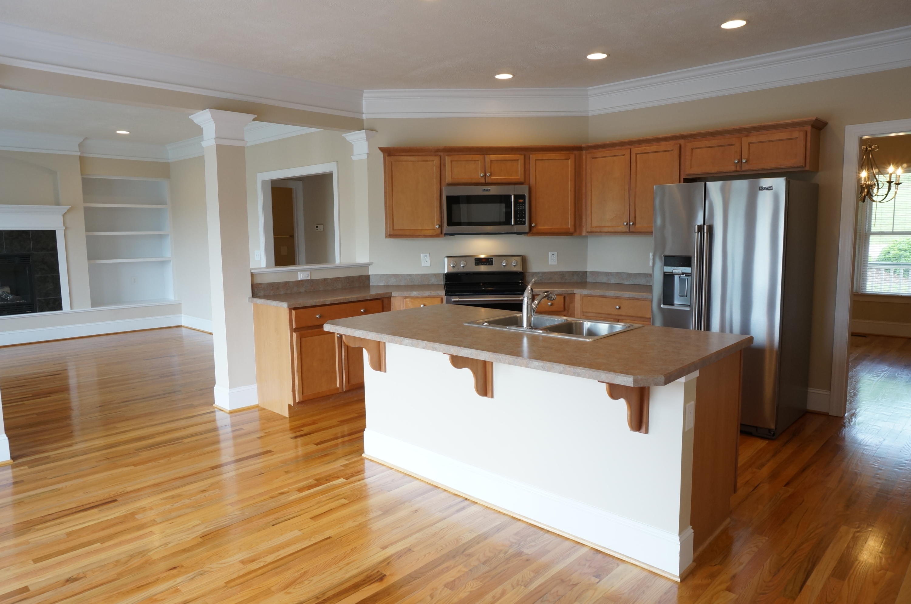5734 North Fork Road Elliston, VA 24087 - Photo 7 of 27 a kitchen with stainless steel appliances granite countertop a stove top oven a sink dishwasher a refrigerator and a microwave oven with wooden floor