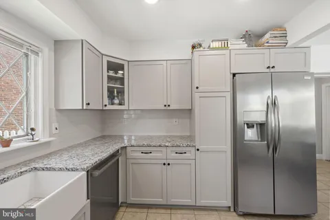 a kitchen with stainless steel appliances granite countertop a refrigerator sink and cabinets