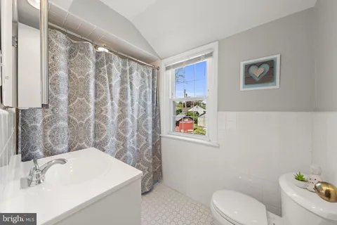 a bathroom with a sink a toilet and tub