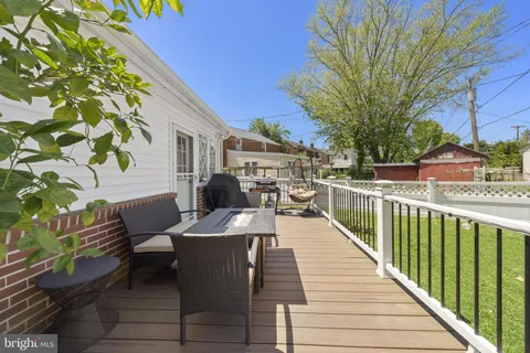 a view of a patio with couches table and chairs and potted plants