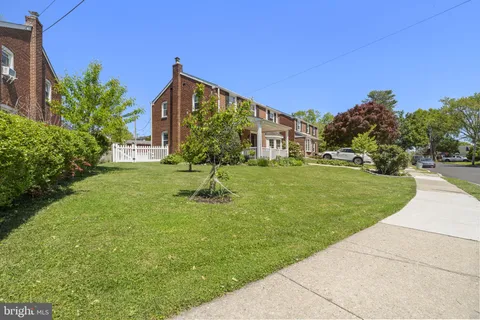 a view of a house with a yard porch and sitting area