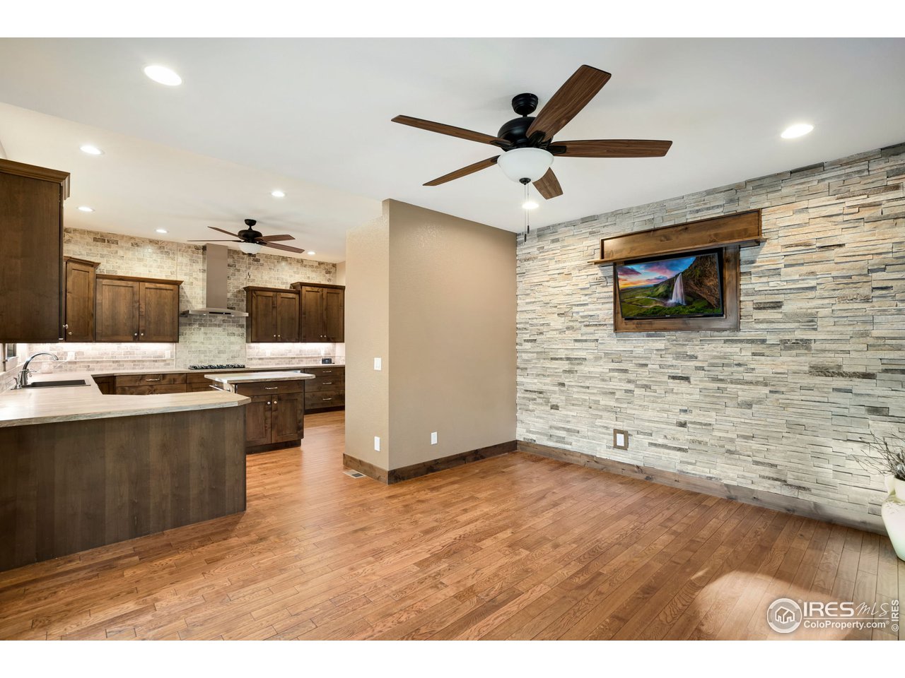 608 Riverside Court Greeley, CO 80634 - Photo 16 of 36 Formal dining with stone accent wall