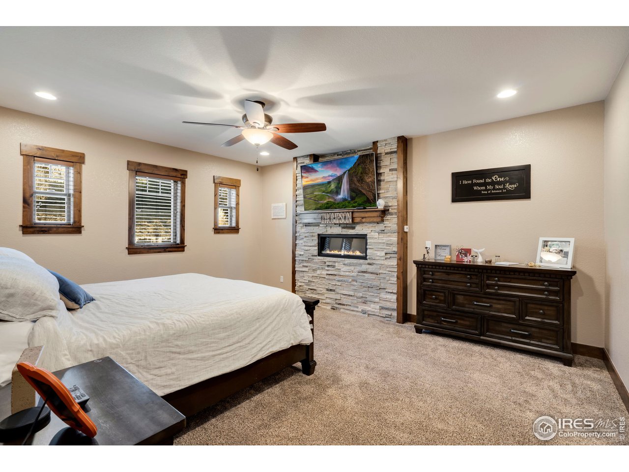 608 Riverside Court Greeley, CO 80634 - Photo 19 of 36 Primary bedroom with linear fireplace