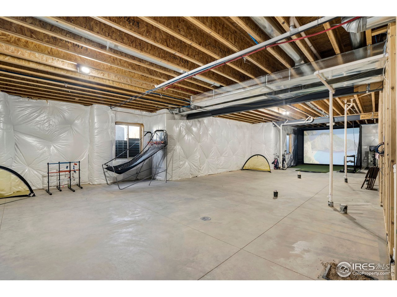 608 Riverside Court Greeley, CO 80634 - Photo 33 of 36 3000sf basement has so much room to expand. Even has space for a golf simulator