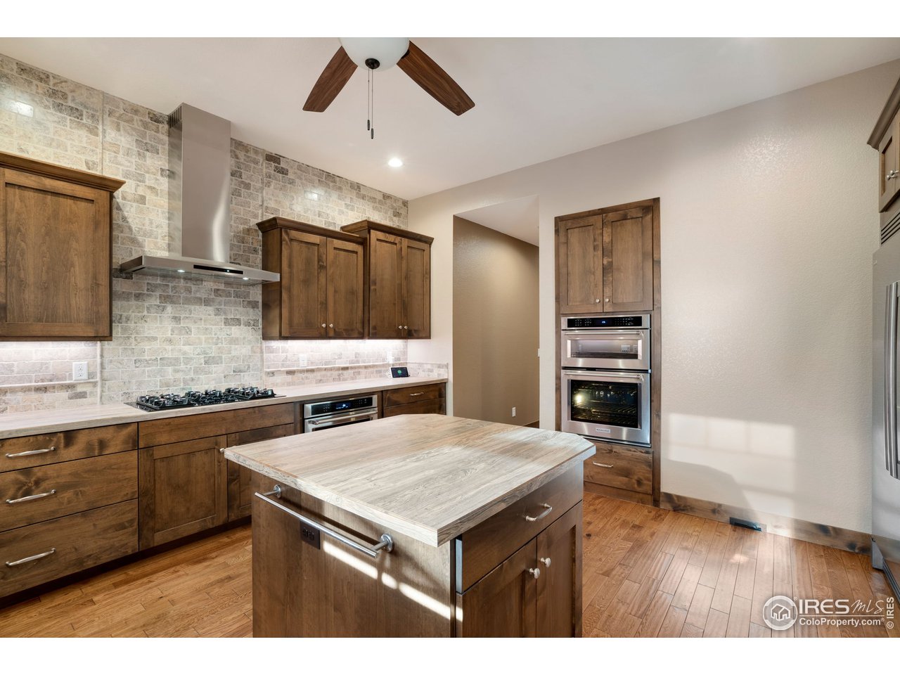 608 Riverside Court Greeley, CO 80634 - Photo 10 of 36 Gourmet kitchen set up with gas range, double oven and built in microwave