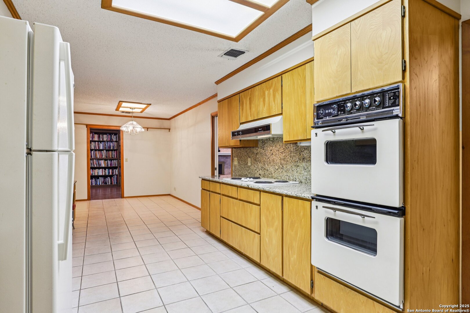 5817 Winding Ridge Drive Windcrest, TX 78239 - Photo 13 of 52 a kitchen with stainless steel appliances a stove a microwave and a refrigerator