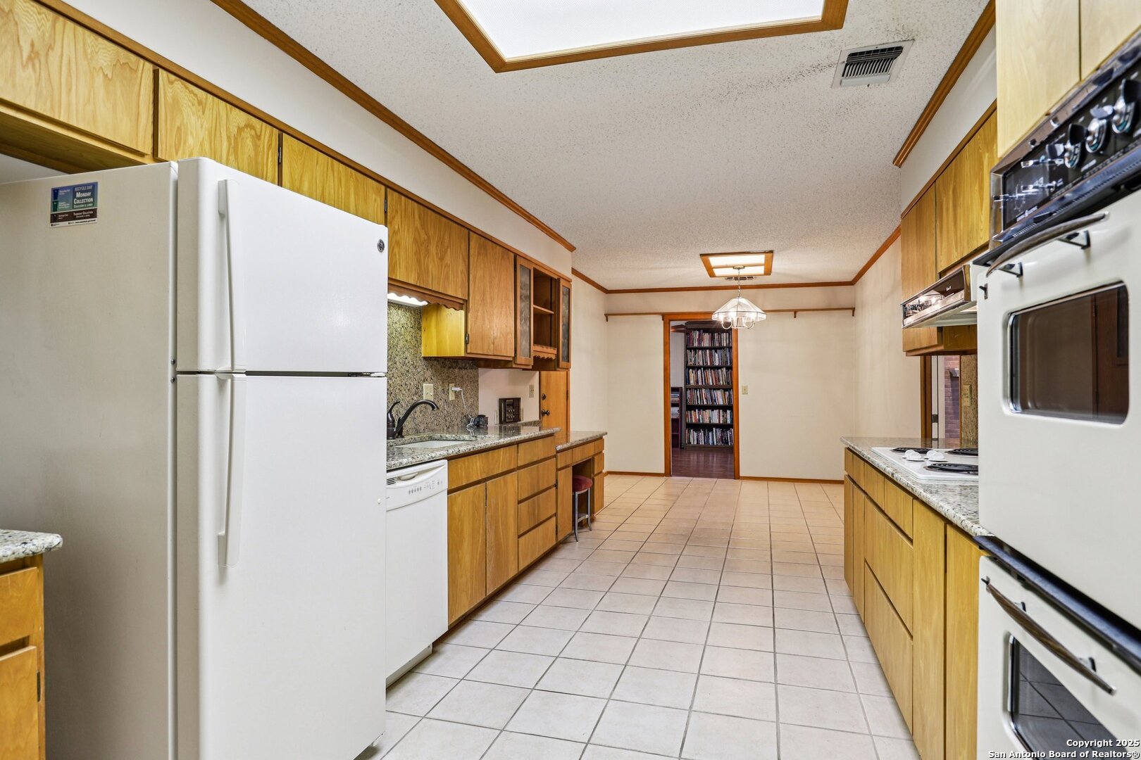 5817 Winding Ridge Drive Windcrest, TX 78239 - Photo 14 of 52 a kitchen with stainless steel appliances a refrigerator sink and cabinets