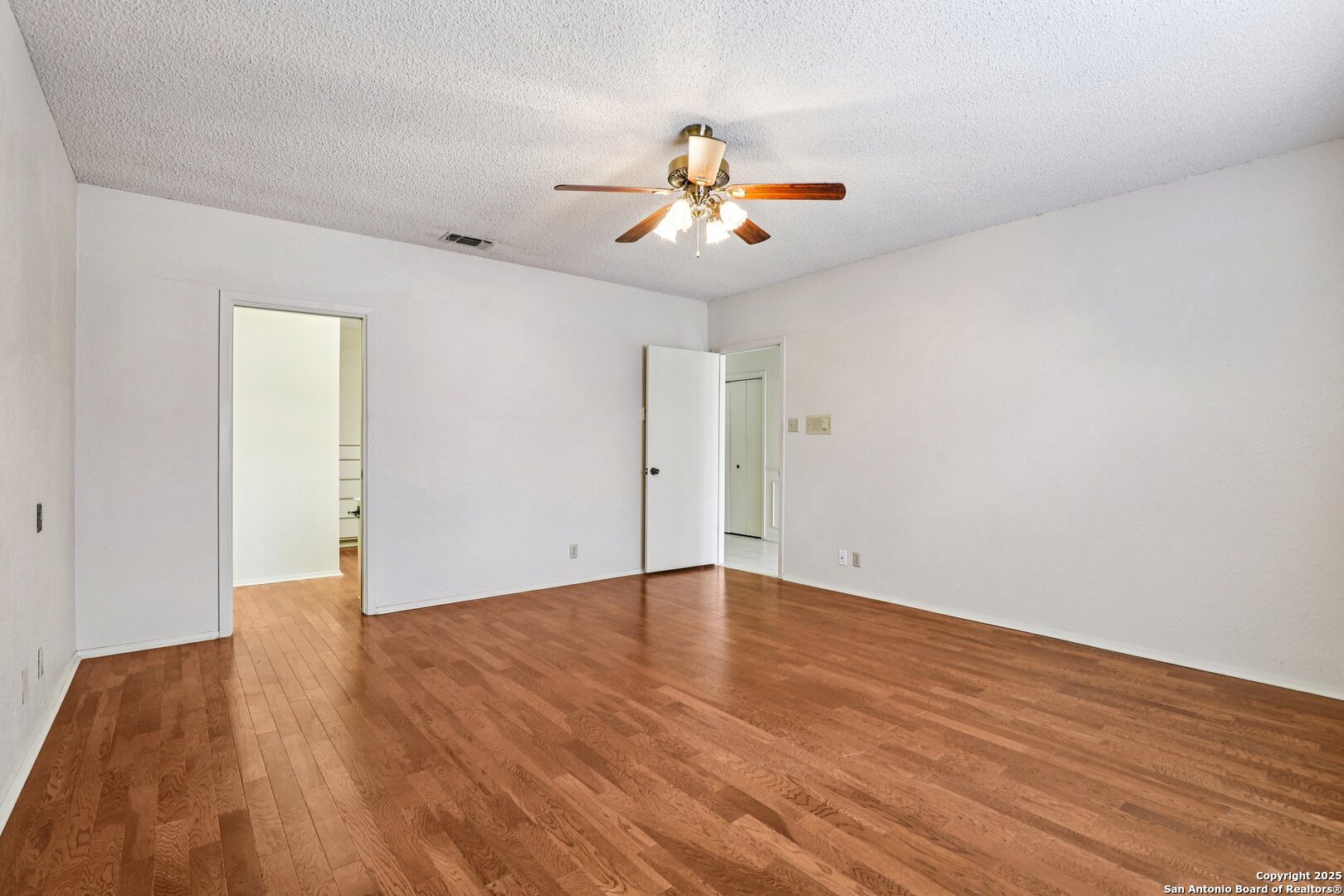 5817 Winding Ridge Drive Windcrest, TX 78239 - Photo 15 of 52 an empty room with wooden floor ceiling fan and window