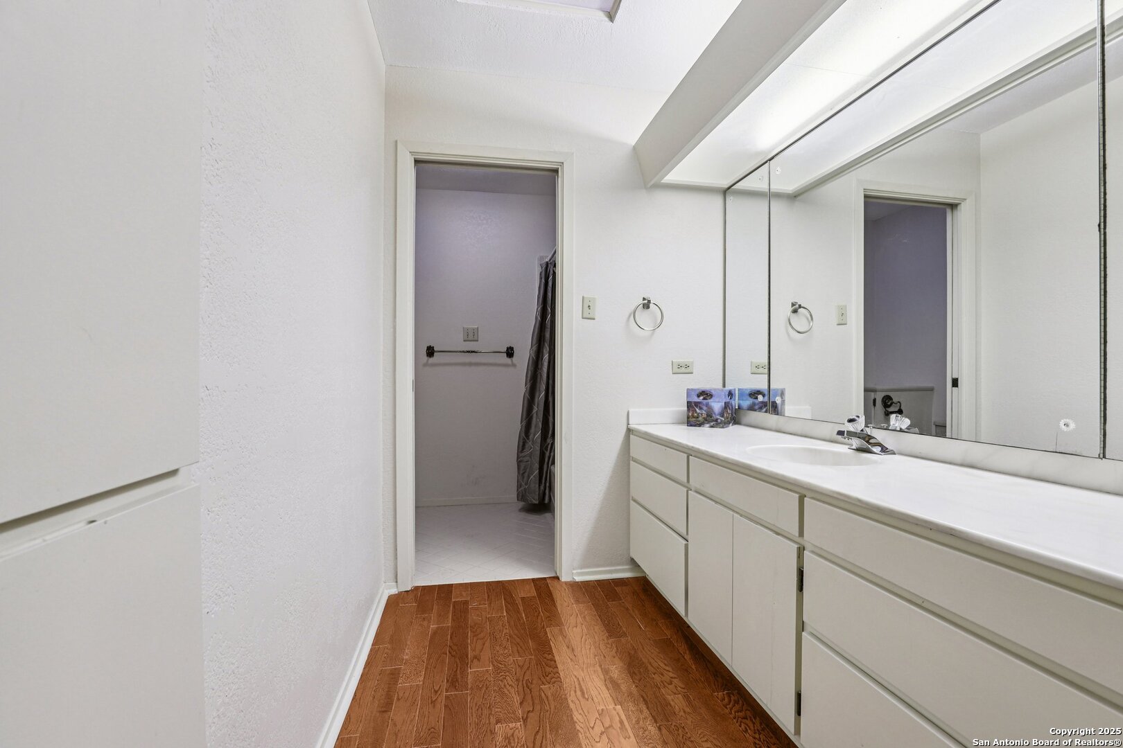 5817 Winding Ridge Drive Windcrest, TX 78239 - Photo 27 of 52 a bathroom with a sink and a mirror