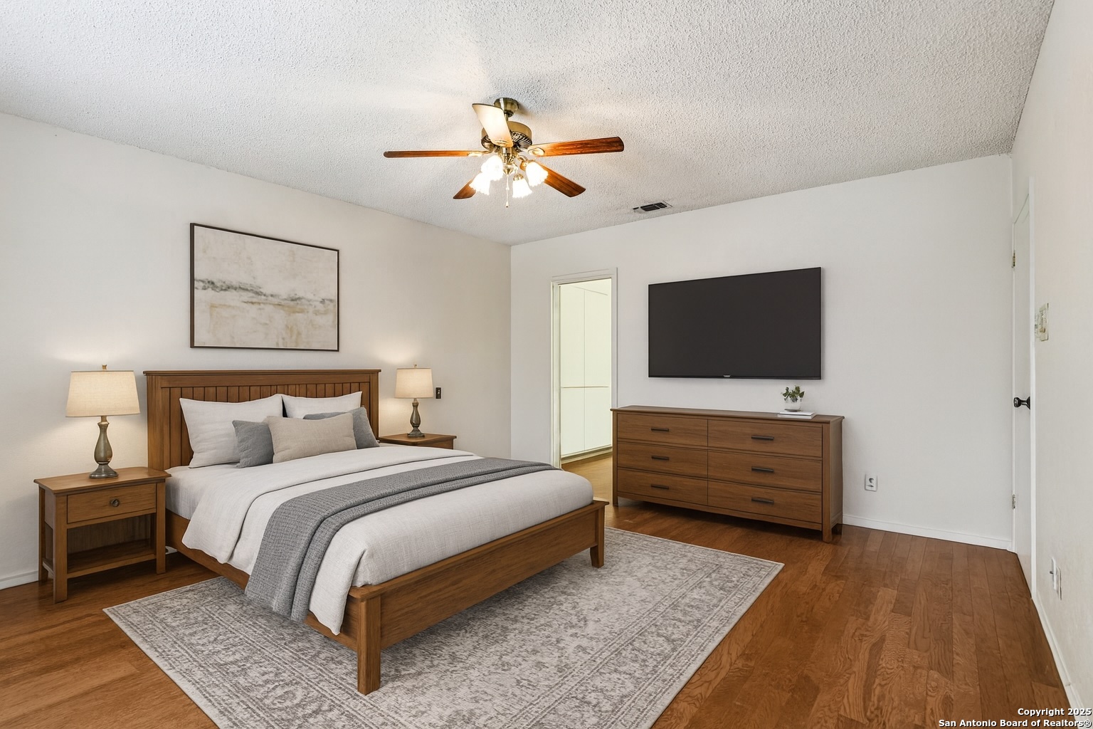 5817 Winding Ridge Drive Windcrest, TX 78239 - Photo 3 of 52 a bed room with a bed a flat screen tv and a chandelier