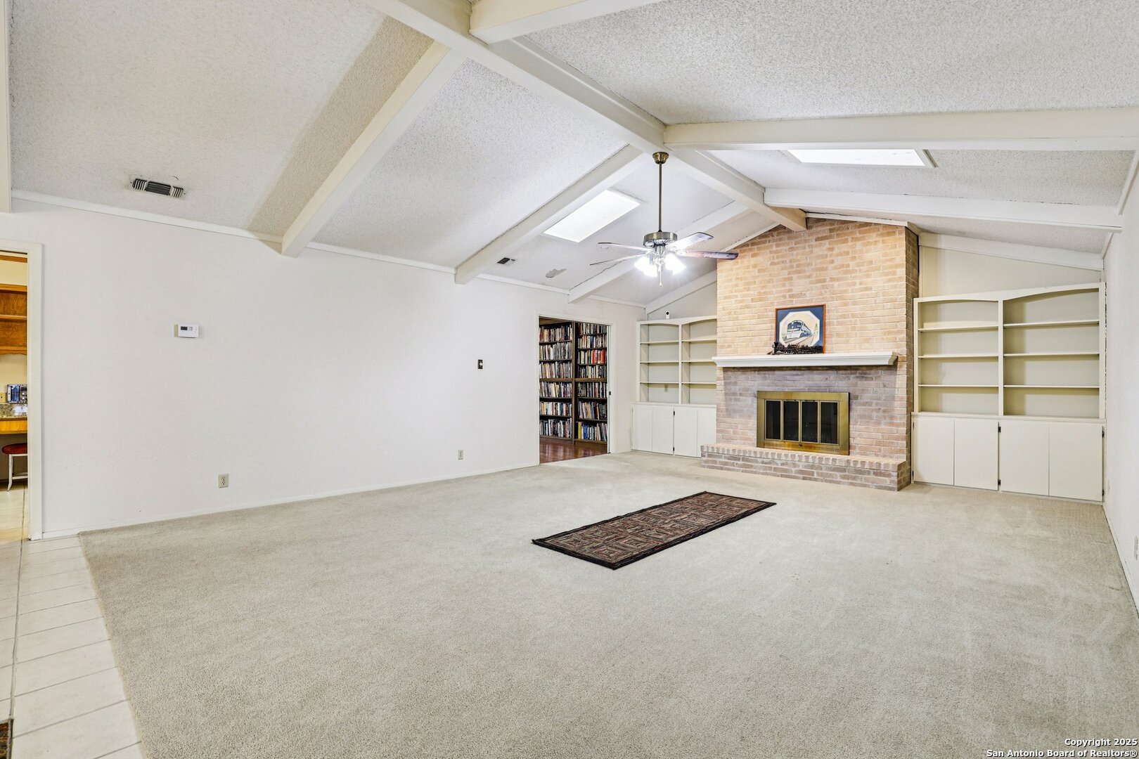 5817 Winding Ridge Drive Windcrest, TX 78239 - Photo 31 of 52 an empty room with fireplace and window
