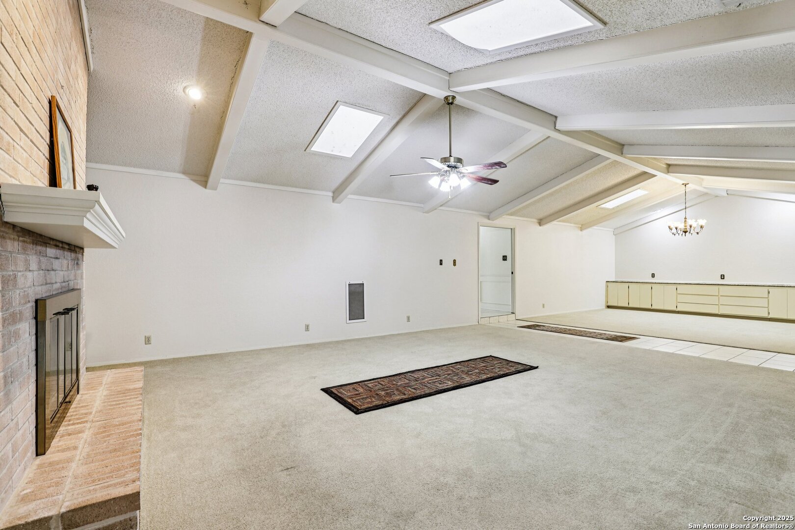 5817 Winding Ridge Drive Windcrest, TX 78239 - Photo 32 of 52 an empty room with chandelier fan and windows