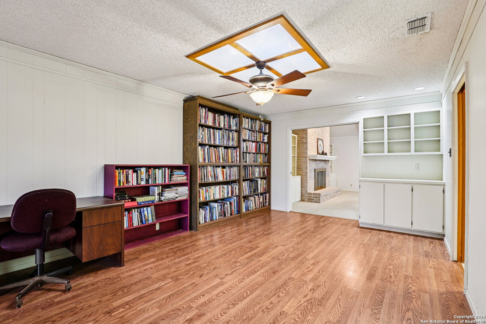 5817 Winding Ridge Drive Windcrest, TX 78239 - Photo 38 of 52 a view of a workspace with furniture and a book shelf