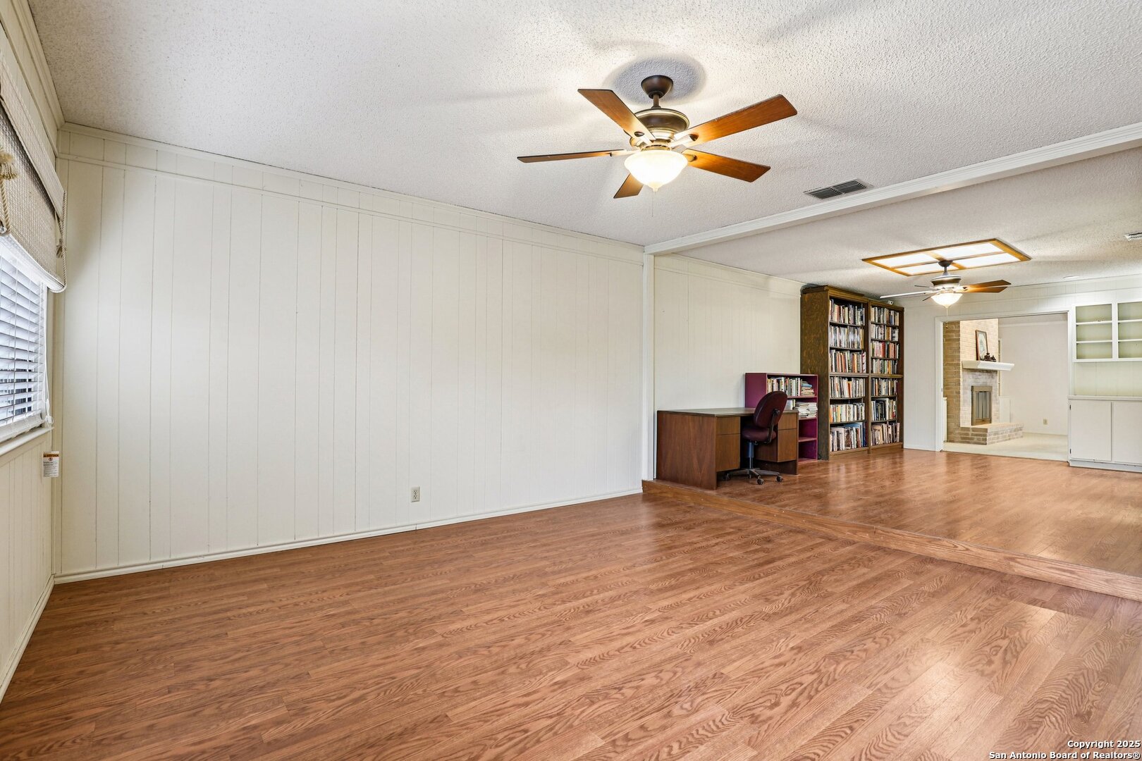 5817 Winding Ridge Drive Windcrest, TX 78239 - Photo 40 of 52 an empty room with wooden floor and chandelier fan
