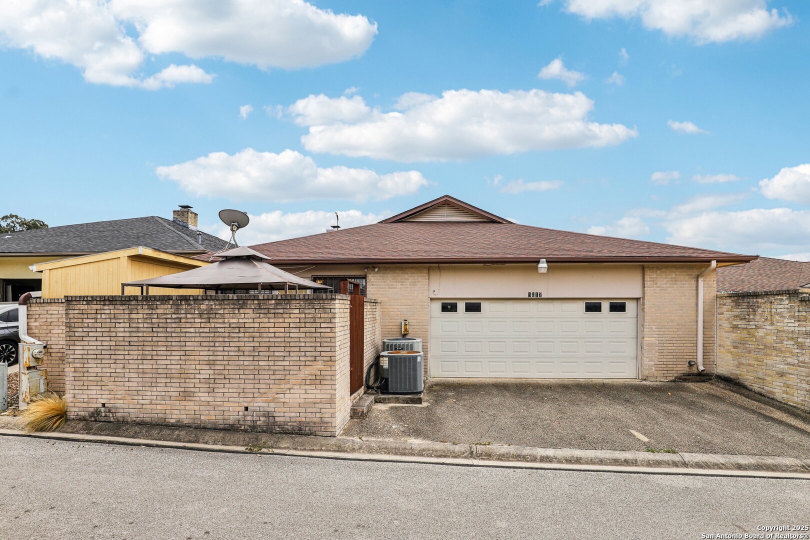 5817 Winding Ridge Drive Windcrest, TX 78239 - Photo 50 of 52 a front view of a house with a yard and garage