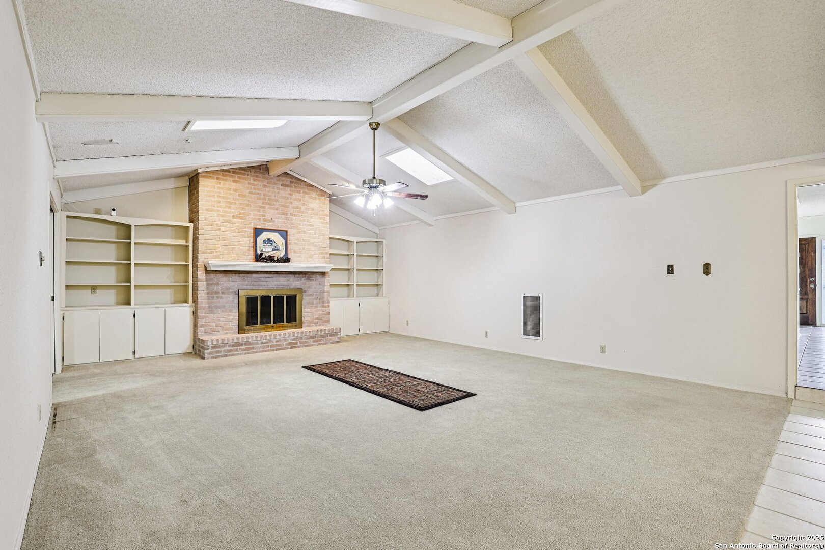 5817 Winding Ridge Drive Windcrest, TX 78239 - Photo 6 of 52 an empty room with fireplace and windows