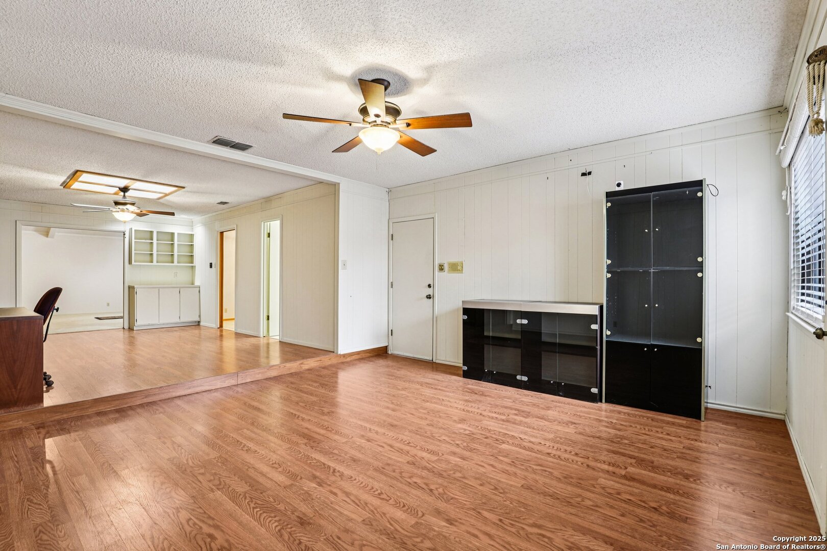 5817 Winding Ridge Drive Windcrest, TX 78239 - Photo 10 of 52 a view of empty room with wooden floor and fan